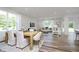 Bright living area with large windows, wood flooring, and comfortable seating arrangements with modern table at 620 Corbin Way, Avon, IN 46123
