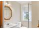 Bathroom with a shower, vanity, toilet, decorative mirror and a window at 625 Mulberry St, Zionsville, IN 46077