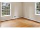 Bright bedroom with wood floors and view of fenced yard at 625 Mulberry St, Zionsville, IN 46077
