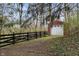 Exterior view of a garage surrounded by mature trees and a black fence at 625 Mulberry St, Zionsville, IN 46077