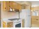 Well-lit kitchen with white appliances and a view to the sunny dining room at 625 Mulberry St, Zionsville, IN 46077