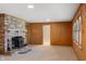 Living room featuring a brick fireplace, neutral carpet, and paneled walls at 625 Mulberry St, Zionsville, IN 46077