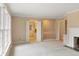 Spacious living room with fireplace, plush carpet, and many windows for natural light at 625 Mulberry St, Zionsville, IN 46077
