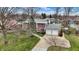 Aerial view of the home featuring a two-car garage and well-maintained landscaping at 6537 Grosvenor Pl, Indianapolis, IN 46220