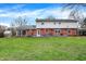 Spacious backyard has a well-manicured lawn and a large deck, great for outdoor entertaining at 6537 Grosvenor Pl, Indianapolis, IN 46220