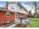 The backyard features a brick house, a gray deck, and an outdoor grill at 6537 Grosvenor Pl, Indianapolis, IN 46220