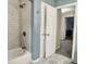 Bright bathroom featuring a shower with white subway tile and a marble floor at 6537 Grosvenor Pl, Indianapolis, IN 46220