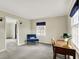 Bright bedroom with hardwood floors and two windows with navy blue blinds at 6537 Grosvenor Pl, Indianapolis, IN 46220