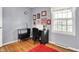 Bright bedroom with hardwood floors, a desk, and natural light from the large window at 6537 Grosvenor Pl, Indianapolis, IN 46220