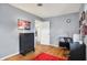 Spacious bedroom with hardwood floors, a desk, and a black dresser against a wall at 6537 Grosvenor Pl, Indianapolis, IN 46220