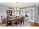 Dining room with wooden table, china cabinet, and French doors leading to living room at 6537 Grosvenor Pl, Indianapolis, IN 46220