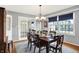 Dining room with a wooden table and chairs, chandelier, and view into the living room at 6537 Grosvenor Pl, Indianapolis, IN 46220