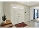 Bright foyer with double front doors, tile flooring, and view into living room at 6537 Grosvenor Pl, Indianapolis, IN 46220