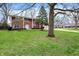 A brick two-story home with manicured lawn and established trees at 6537 Grosvenor Pl, Indianapolis, IN 46220