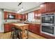 Well-lit kitchen with stainless steel appliances, wood cabinets, and butcher block island at 6537 Grosvenor Pl, Indianapolis, IN 46220