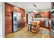 Updated kitchen with wood cabinets, stainless steel appliances, hardwood floors and a central island at 6537 Grosvenor Pl, Indianapolis, IN 46220