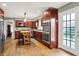 Spacious kitchen with wood cabinets, stainless steel appliances, an island, and hardwood flooring at 6537 Grosvenor Pl, Indianapolis, IN 46220