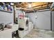 Basement laundry room with modern washer and dryer, utility sink, and white painted walls at 6537 Grosvenor Pl, Indianapolis, IN 46220