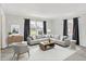 Bright living room features neutral decor, large windows, and stylish furnishings at 6537 Grosvenor Pl, Indianapolis, IN 46220