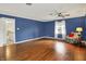 Spacious main bedroom with hardwood floors, ceiling fan, and large window at 6537 Grosvenor Pl, Indianapolis, IN 46220