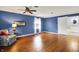 Main bedroom features hardwood floors, ceiling fan, and access to en-suite bathroom at 6537 Grosvenor Pl, Indianapolis, IN 46220