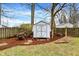 Backyard shed with double doors on a lot with mulch ground cover at 6537 Grosvenor Pl, Indianapolis, IN 46220