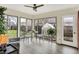 Bright sunroom with floor-to-ceiling windows, a ceiling fan, and backyard access at 6537 Grosvenor Pl, Indianapolis, IN 46220