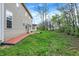 Large, grassy backyard showcasing the home's exterior and the surrounding greenery at 7562 Black Walnut Dr, Avon, IN 46123