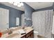 Bathroom featuring a double sink vanity, a toilet, and a shower with a polka dot curtain at 7562 Black Walnut Dr, Avon, IN 46123
