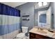 Cozy bathroom featuring a toilet, vanity, and shower with a blue and white striped curtain at 7562 Black Walnut Dr, Avon, IN 46123
