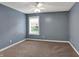 Bright bedroom with neutral carpet, light-filled window, and a modern ceiling fan at 7562 Black Walnut Dr, Avon, IN 46123