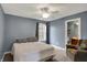 Bedroom with carpeted floors, ceiling fan, and view to ensuite bathroom at 7562 Black Walnut Dr, Avon, IN 46123