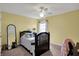 Yellow-walled bedroom with a twin bed, ceiling fan, and window at 7562 Black Walnut Dr, Avon, IN 46123