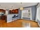 Bright dining area with hardwood floors, pendant lighting, and a large window with white curtains at 7562 Black Walnut Dr, Avon, IN 46123