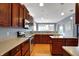 Beautiful kitchen boasting stainless steel appliances, cherry wood cabinetry, and hardwood floors for easy cleanup at 7562 Black Walnut Dr, Avon, IN 46123