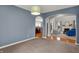 Open-concept living space featuring carpet, arched doorways, and access to the kitchen and living room at 7562 Black Walnut Dr, Avon, IN 46123