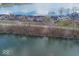 Aerial view showcases the lakeside neighborhood with lush greenery and private docks, blending nature with home at 7653 River Rd, Indianapolis, IN 46240