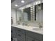 A modern bathroom with double sinks, sleek countertops, and stylish mirrors at 7653 River Rd, Indianapolis, IN 46240