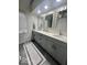 Stylish bathroom with double sinks, modern fixtures, and a decorative rug at 7653 River Rd, Indianapolis, IN 46240