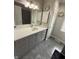 This renovated bathroom features stylish gray cabinetry and elegant countertops at 7653 River Rd, Indianapolis, IN 46240