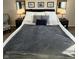 A well-decorated bedroom featuring a comfortable bed with stylish lighting and decor at 7653 River Rd, Indianapolis, IN 46240
