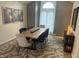 Dining room with a modern wooden table, stylish chairs, and elegant decor against neutral-colored walls at 7653 River Rd, Indianapolis, IN 46240