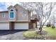 Charming townhouse with a two-car garage, balcony, and manicured front lawn at 7653 River Rd, Indianapolis, IN 46240