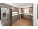 Well-lit kitchen featuring gray cabinets, stainless steel appliances, tile backsplash, and sleek quartz countertops at 7653 River Rd, Indianapolis, IN 46240