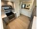 Efficient kitchen with stainless steel oven and view into living area, enhanced by neutral tones and tile backsplash at 7653 River Rd, Indianapolis, IN 46240