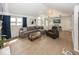 Bright living room features vaulted ceilings, a modern sectional sofa, and large windows with waterfront views at 7653 River Rd, Indianapolis, IN 46240