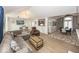 Spacious living room featuring modern furnishings, an open layout, and easy access to dining and kitchen areas at 7653 River Rd, Indianapolis, IN 46240
