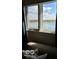 Window view overlooking a serene lake with blue skies and a picturesque waterfront community in the distance at 7653 River Rd, Indianapolis, IN 46240