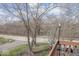 Outdoor view from the deck with mature trees and community road at 7653 River Rd, Indianapolis, IN 46240