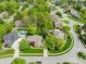 Beautiful aerial view of homes in a residential area with mature trees and a community pool at 7732 Ashtree Dr, Indianapolis, IN 46259